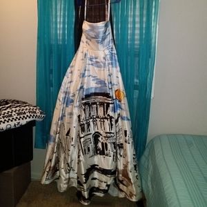 Jovoni ball gown with buildings and sunset on bottom of gown. This is a size 4